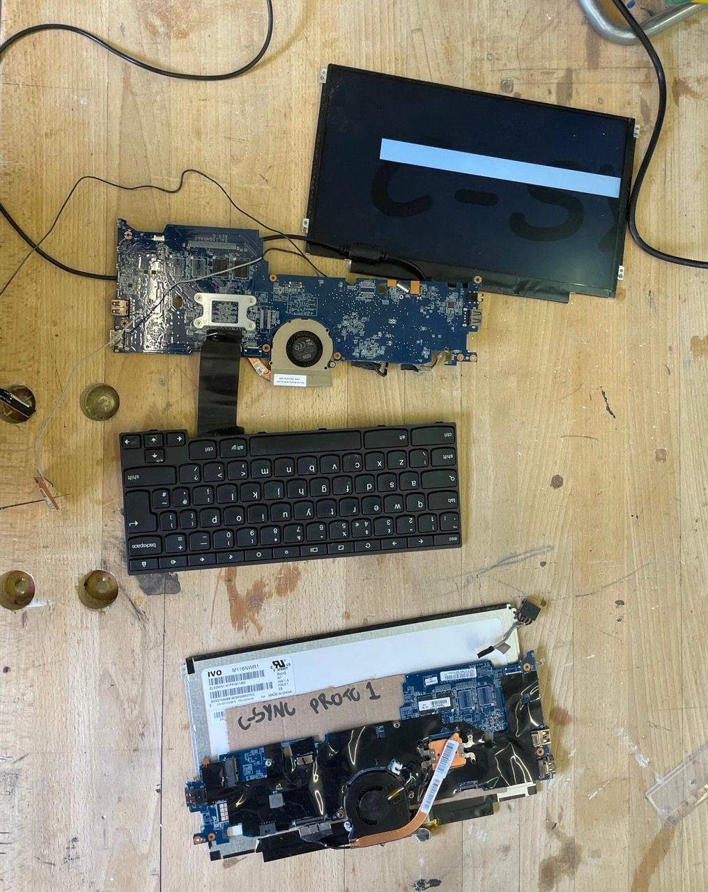 Bare laptop motherboard, keyboard and screen